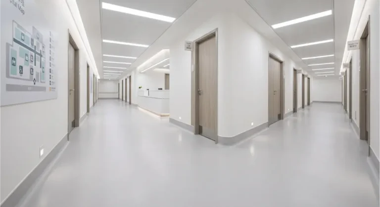 seamless healthcare flooring with integral cove base in modern hospital corridor