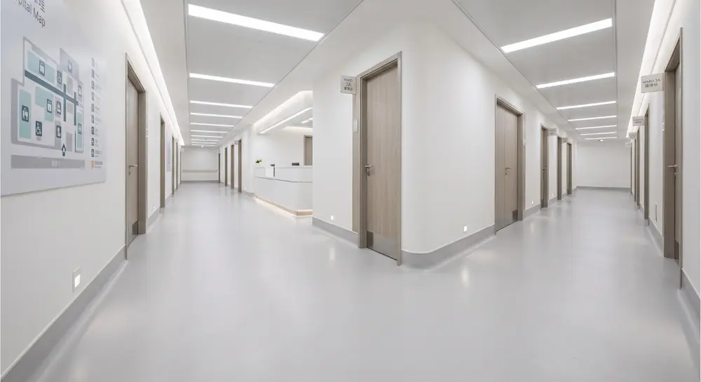 seamless healthcare flooring with integral cove base in modern hospital corridor